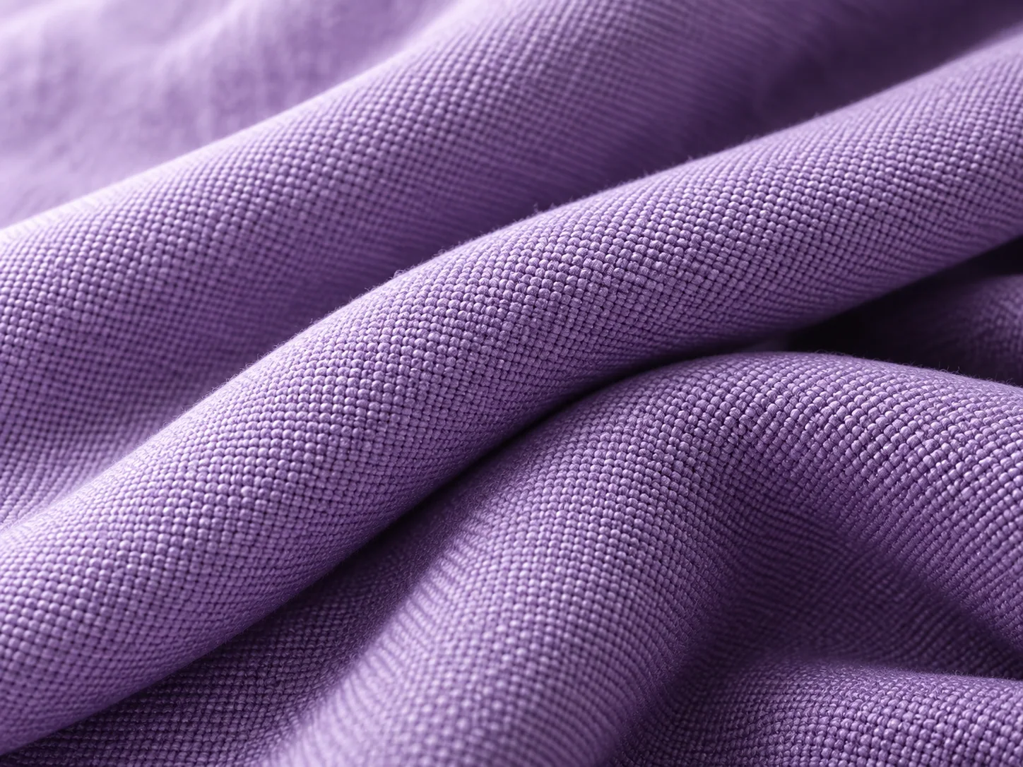Close-up of lavender woven fabric in soft folds.